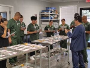 An SPD instructor leading a hands-on activity focused on surgical instrument identification.
